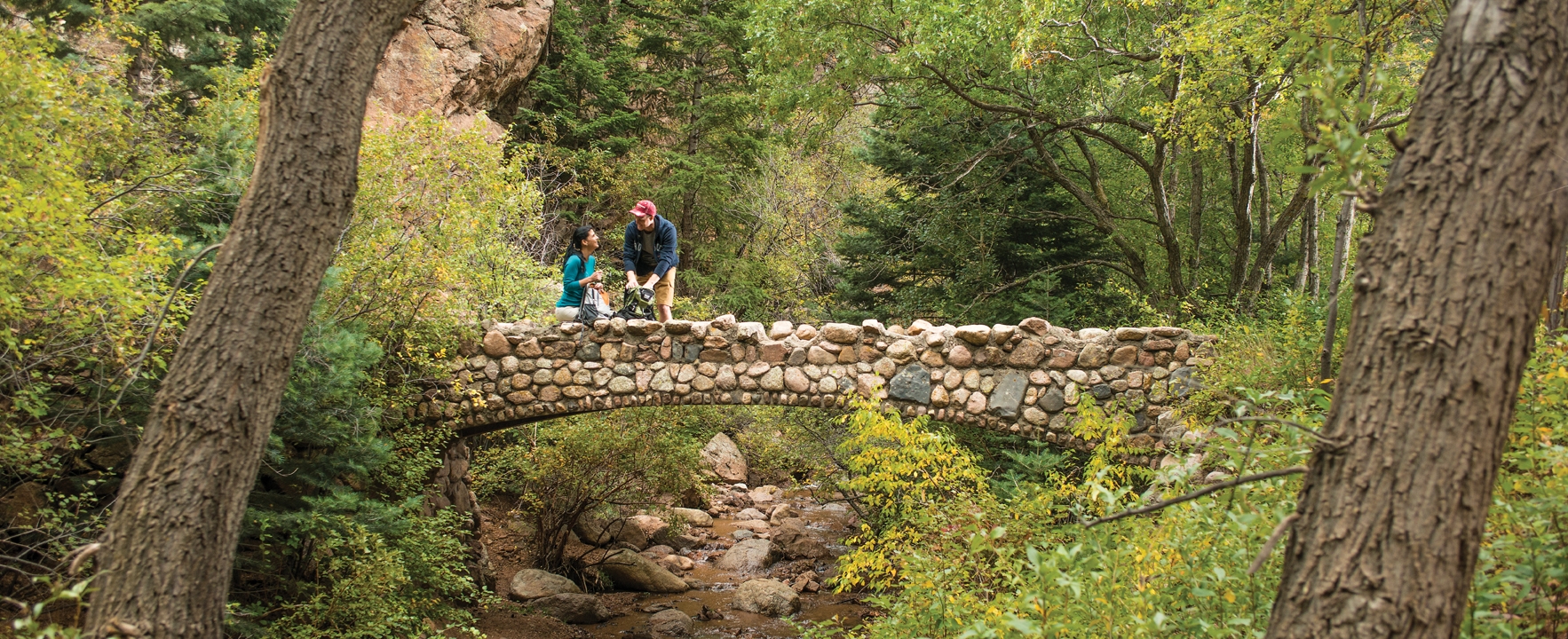 A man and woman hiking on a bridge in Colorado Springs