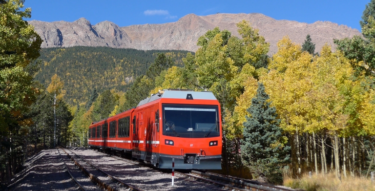 Train on tracks with mountain views