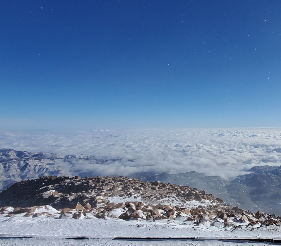 A Snowy Landscape With Mountains In The Background